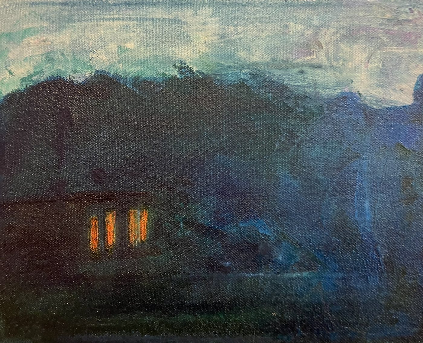 Near-black hills under a teal sky, with four narrow orange windows glowing low in the dark